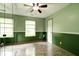 Green bedroom featuring a spacious closet, hardwood floors and large windows at 12157 Longstraw Dr, Indianapolis, IN 46236