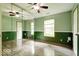Green bedroom featuring mirrored closet doors and large windows at 12157 Longstraw Dr, Indianapolis, IN 46236