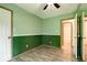 Green bedroom featuring a spacious closet, hardwood floors and large windows at 12157 Longstraw Dr, Indianapolis, IN 46236
