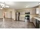 Contemporary kitchen featuring stainless steel appliances, gray cabinetry, and hardwood floors at 12157 Longstraw Dr, Indianapolis, IN 46236
