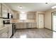Well-lit kitchen offers stainless steel appliances, gray cabinets, and wood-look flooring at 12157 Longstraw Dr, Indianapolis, IN 46236
