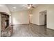 Inviting living room features a brick fireplace, wood-look flooring, and neutral paint colors at 12157 Longstraw Dr, Indianapolis, IN 46236