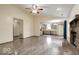 Open-concept living room flows into the kitchen, featuring wood-look floors and a brick fireplace at 12157 Longstraw Dr, Indianapolis, IN 46236