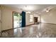 Open living area with sliding glass doors to patio, fireplace and wood-look floors at 12157 Longstraw Dr, Indianapolis, IN 46236