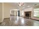 Spacious living room featuring a brick fireplace, wood-look flooring, and ample natural light at 12157 Longstraw Dr, Indianapolis, IN 46236