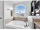 Bright bathroom featuring a soaking tub and a large window at 1313 Brentford Ln, Greenwood, IN 46143