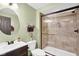 Modern bathroom with tiled shower, contemporary fixtures, and vanity with sink at 1313 Brentford Ln, Greenwood, IN 46143