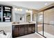 Bright bathroom featuring a soaking tub, stylish vanity, and a glass door shower at 1313 Brentford Ln, Greenwood, IN 46143