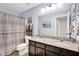 Bathroom with double sinks, granite countertop, and neutral-toned shower curtain at 1313 Brentford Ln, Greenwood, IN 46143