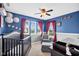 Charming Bedroom featuring baseball themed decorations, a crib, and a comfortable armchair at 1313 Brentford Ln, Greenwood, IN 46143