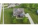 Two-story home with brick and siding with manicured lawn and beautiful landscaping at 1313 Brentford Ln, Greenwood, IN 46143