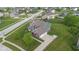 Two-story home with brick and siding, three car garage, basketball hoop, and manicured lawn at 1313 Brentford Ln, Greenwood, IN 46143