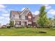 Charming two-story brick home featuring a welcoming front porch and lush lawn at 1313 Brentford Ln, Greenwood, IN 46143