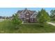 Stunning two-story home featuring a well-manicured lawn and mature trees, showcasing curb appeal at 1313 Brentford Ln, Greenwood, IN 46143
