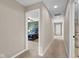 Hallway leads to bedroom with ceiling fan and carpeted floors, showing natural light at 1313 Brentford Ln, Greenwood, IN 46143