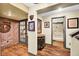 Well-lit hallway showcasing decorative art and access to the home's rooms at 1313 Brentford Ln, Greenwood, IN 46143