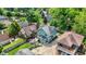 Beautiful green home with a spacious wooden deck, basketball hoop, and well-manicured lawn at 140 W Hampton Dr, Indianapolis, IN 46208
