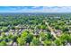 Scenic aerial view of a residential neighborhood with tree-lined streets during summer at 140 W Hampton Dr, Indianapolis, IN 46208