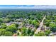 Aerial view of a neighborhood with tree-lined streets and mature trees in summer at 140 W Hampton Dr, Indianapolis, IN 46208
