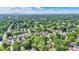 Aerial view of neighborhood with tree-lined streets on sunny day in summer at 140 W Hampton Dr, Indianapolis, IN 46208