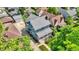 Aerial view of a blue house featuring a landscaped front yard and a welcoming front porch at 140 W Hampton Dr, Indianapolis, IN 46208