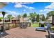 Spacious back deck featuring a dining table, lounge chair, grill, and shade umbrella for outdoor relaxation at 140 W Hampton Dr, Indianapolis, IN 46208