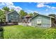 Expansive backyard with a wooden deck and a well-maintained lawn with a detached garage, ideal for outdoor enjoyment at 140 W Hampton Dr, Indianapolis, IN 46208