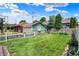 Green backyard with a well-maintained lawn, white picket fence, and garden shed at 140 W Hampton Dr, Indianapolis, IN 46208