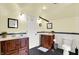 Modern bathroom with tiled floors, dual vanities, and tiled walls at 140 W Hampton Dr, Indianapolis, IN 46208