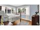 Bright bedroom with light blue walls, hardwood floors, and large windows with lots of natural light at 140 W Hampton Dr, Indianapolis, IN 46208