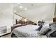 Bedroom with a carpeted floor, wooden trim, a unique ceiling and opening to other rooms at 140 W Hampton Dr, Indianapolis, IN 46208