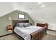 Bedroom with a carpeted floor, wooden trim, a unique ceiling and large bed at 140 W Hampton Dr, Indianapolis, IN 46208