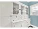 Charming vintage built-in hutch with glass display, drawers, and storage in dining area at 140 W Hampton Dr, Indianapolis, IN 46208