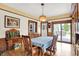 Traditional dining room with hardwood floors and view to backyard deck and vintage decorations at 140 W Hampton Dr, Indianapolis, IN 46208