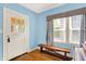 Bright entryway featuring hardwood floors, a window seat, and a front door with glass panels at 140 W Hampton Dr, Indianapolis, IN 46208