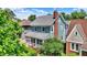 Charming home with a screened front porch, mature landscaping and a classic roof line, nestled among lush greenery at 140 W Hampton Dr, Indianapolis, IN 46208