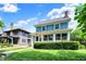Beautiful home with a well-kept lawn, vibrant landscaping, and a cozy enclosed front porch on a tree lined street at 140 W Hampton Dr, Indianapolis, IN 46208