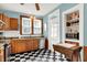 Well-lit kitchen features stainless steel appliances and checkered floors with vintage cabinetry at 140 W Hampton Dr, Indianapolis, IN 46208