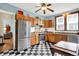 Traditional kitchen with stainless steel appliances, checkerboard floors, and wood cabinets at 140 W Hampton Dr, Indianapolis, IN 46208