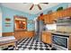 Eat-in kitchen features stainless steel appliances, checkerboard floors, and oak cabinets at 140 W Hampton Dr, Indianapolis, IN 46208