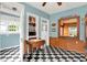 Eat-in kitchen with a view into the dining room features checkerboard floors at 140 W Hampton Dr, Indianapolis, IN 46208