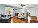Bright living room featuring hardwood floors, soft blue walls, and a glass coffee table at 140 W Hampton Dr, Indianapolis, IN 46208