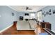 Bright living room with hardwood floors, fireplace, ceiling fan, and large windows at 140 W Hampton Dr, Indianapolis, IN 46208