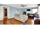 Bright living room featuring hardwood floors, soft blue walls, a fireplace, and lots of natural light at 140 W Hampton Dr, Indianapolis, IN 46208