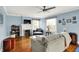 Bright living room with hardwood floors, blue walls, fireplace, and lots of natural light at 140 W Hampton Dr, Indianapolis, IN 46208