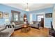 Open-concept living room with hardwood floors, two sofas, and ample natural light at 140 W Hampton Dr, Indianapolis, IN 46208