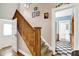 Traditional staircase featuring wood banister, carpeted steps, and decorative wall art at 140 W Hampton Dr, Indianapolis, IN 46208