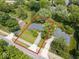 Aerial view of a house with a lush front yard and spacious driveway, surrounded by mature trees at 1408 126Th St, Carmel, IN 46033
