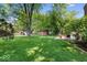 Spacious backyard with a manicured lawn, mature trees, and a patio area for outdoor entertaining at 1408 126Th St, Carmel, IN 46033