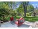 Relaxing backyard patio with comfortable seating, lush landscaping, and a playset at 1408 126Th St, Carmel, IN 46033